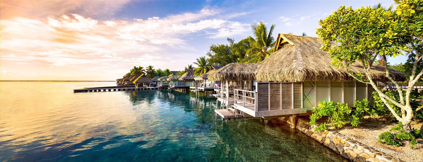 Luxury water villa at night representing hospitality-backed real estate